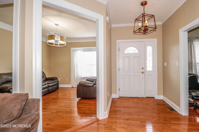 45 Sugar Hill Rd, Manahawkin, NJ 08050 - foyer entrance featuring light wood-style floors, a chandelier, and ornamental molding