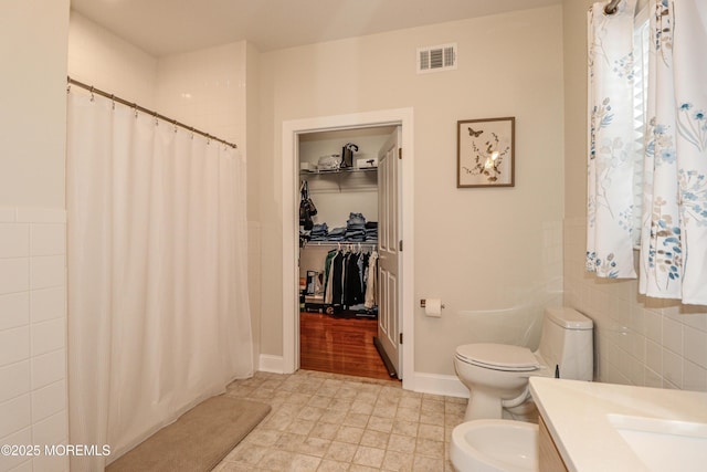 45 Sugar Hill Rd, Manahawkin, NJ 08050 - full bath featuring tile walls, vanity, a shower with shower curtain, a bidet, and a walk in closet