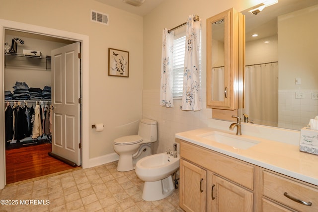 45 Sugar Hill Rd, Manahawkin, NJ 08050 - bathroom with a bidet, vanity, tile walls, a spacious closet, and a shower with curtain