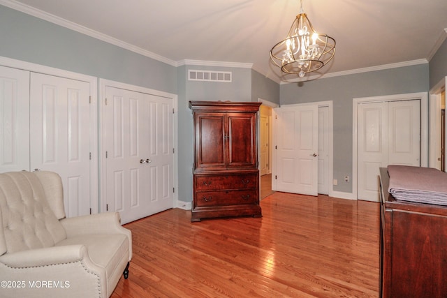 45 Sugar Hill Rd, Manahawkin, NJ 08050 - living area featuring a chandelier, light wood finished floors, and ornamental molding