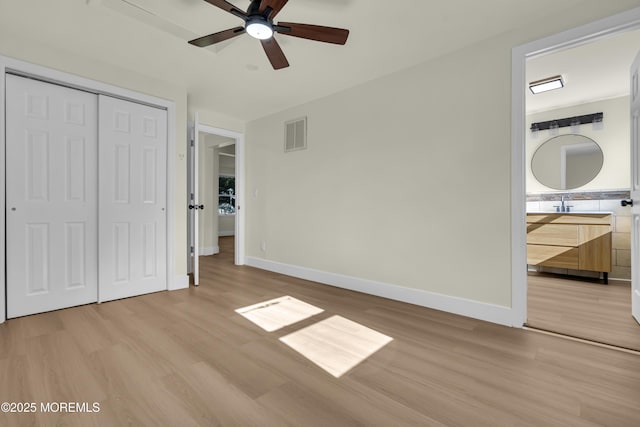 626 Clark Ave, Union Beach, NJ 07735 - unfurnished bedroom with light wood-style floors, a closet, ensuite bath, and a ceiling fan