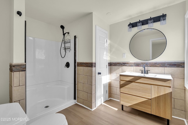 626 Clark Ave, Union Beach, NJ 07735 - full bath with tile walls, wood finished floors, a wainscoted wall, vanity, and a shower