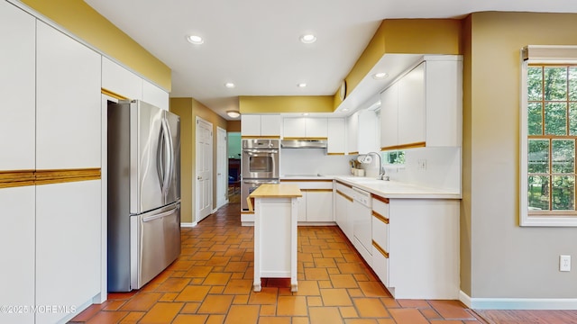 26 Appomattox Dr, Manalapan, NJ 07726 - kitchen with stainless steel appliances, white cabinetry, a center island, recessed lighting, and under cabinet range hood