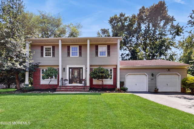 26 Appomattox Dr, Manalapan, NJ 07726 - view of front facade with an attached garage, driveway, and a front yard