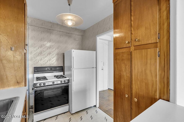 510 Deal Lake Dr Unit 8F, Asbury Park, NJ 07712 - kitchen with white appliances, brown cabinetry, light countertops, and light floors