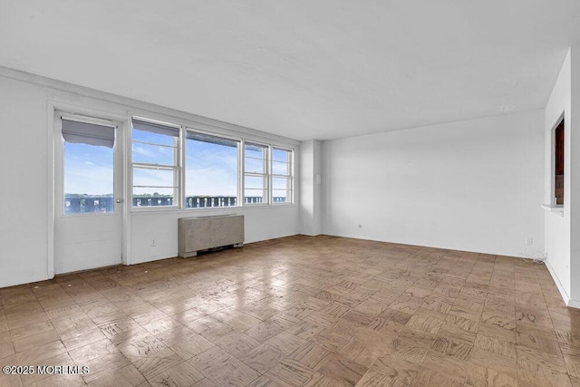 510 Deal Lake Dr Unit 8F, Asbury Park, NJ 07712 - unfurnished room with radiator and healthy amount of natural light