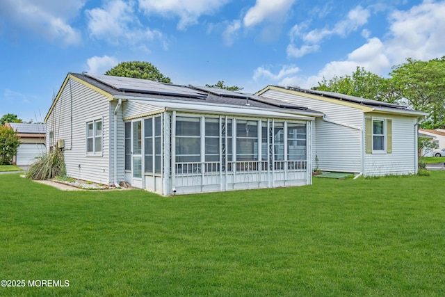 81 Falmouth Ave Unit 72, Whiting, NJ 08759 - back of house featuring a sunroom, a lawn, and roof mounted solar panels