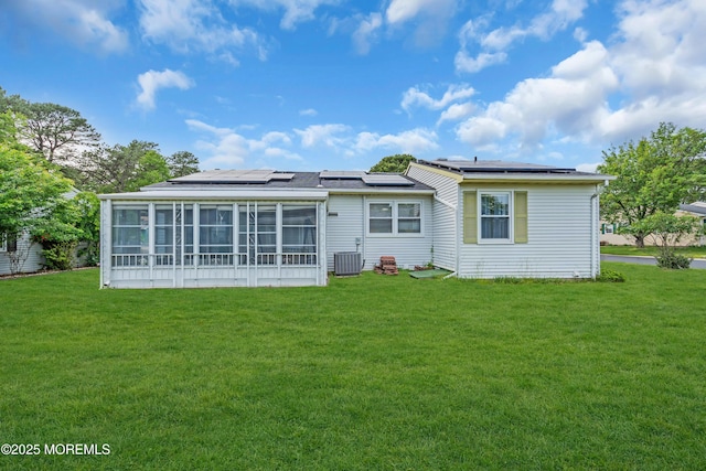 81 Falmouth Ave Unit 72, Whiting, NJ 08759 - back of property featuring a sunroom, a yard, and roof mounted solar panels