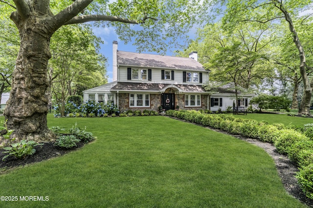 6 Buttonwood Dr, Shrewsbury Boro, NJ 07702 - view of front of home with a chimney, a front lawn, and stone siding