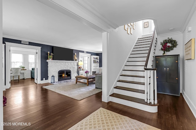 6 Buttonwood Dr, Shrewsbury Boro, NJ 07702 - staircase featuring ornamental molding, wood finished floors, plenty of natural light, and a fireplace