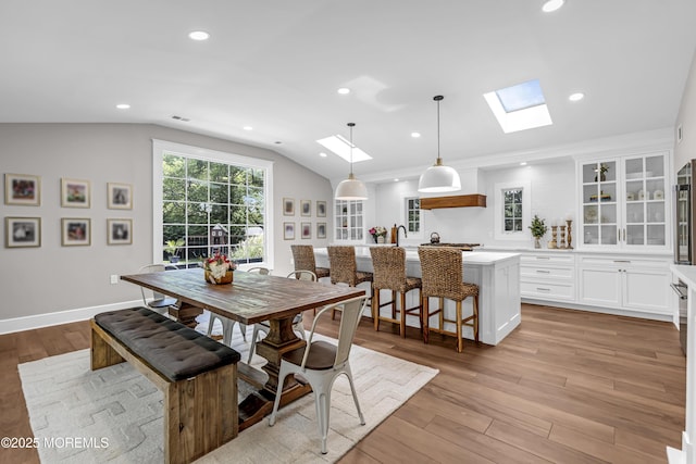 6 Buttonwood Dr, Shrewsbury Boro, NJ 07702 - dining space featuring a skylight, lofted ceiling, light wood-style floors, and recessed lighting