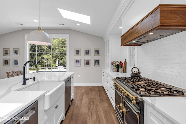 6 Buttonwood Dr, Shrewsbury Boro, NJ 07702 - kitchen with premium range hood, stainless steel appliances, lofted ceiling, tasteful backsplash, and dark wood-style flooring