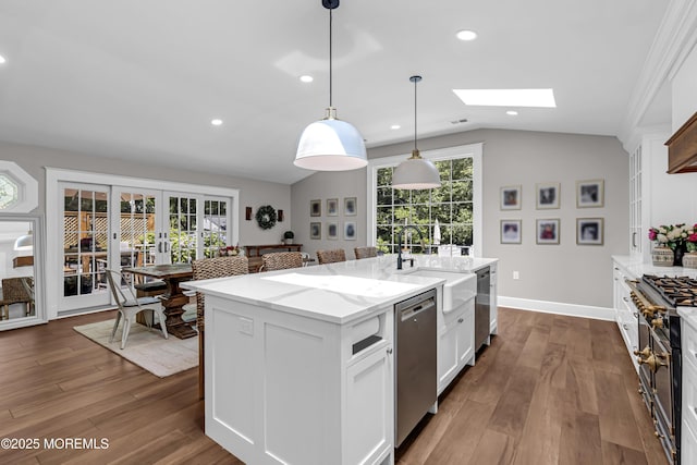 6 Buttonwood Dr, Shrewsbury Boro, NJ 07702 - kitchen featuring stainless steel dishwasher, lofted ceiling, a skylight, light stone countertops, and french doors