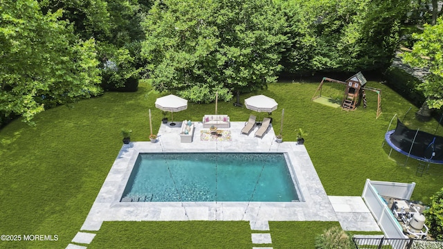 6 Buttonwood Dr, Shrewsbury Boro, NJ 07702 - swimming pool with a trampoline, a patio area, a lawn, and a playground