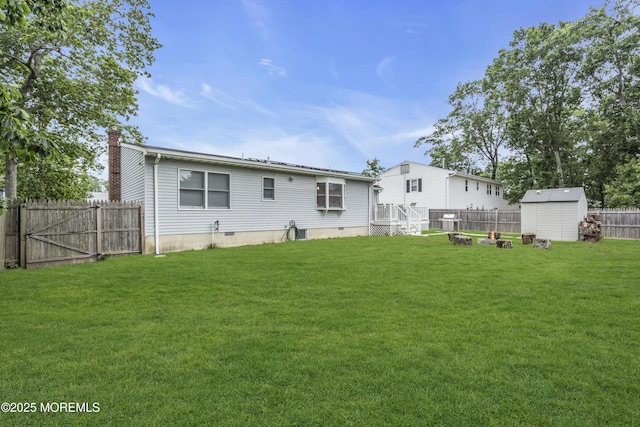235 Willow Ln, Forked River, NJ 08731 - back of property featuring a storage unit, a fenced backyard, and a chimney