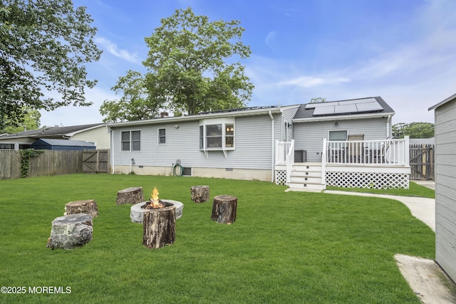 235 Willow Ln, Forked River, NJ 08731 - rear view of property with a fire pit, a deck, and solar panels