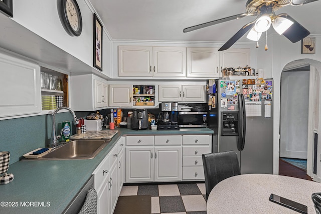 207 Lloyd Rd, Matawan, NJ 07747 - kitchen featuring stainless steel appliances, arched walkways, ceiling fan, dark flooring, and white cabinets