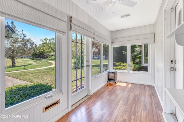 404 Picardy Ct Unit A, Lakewood, NJ 08701 - unfurnished sunroom featuring wood finished floors and a wood stove