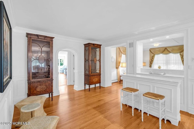 1905 3rd Ave, Spring Lake, NJ 07762 - living area featuring a decorative wall, arched walkways, light wood finished floors, ornamental molding, and a wainscoted wall