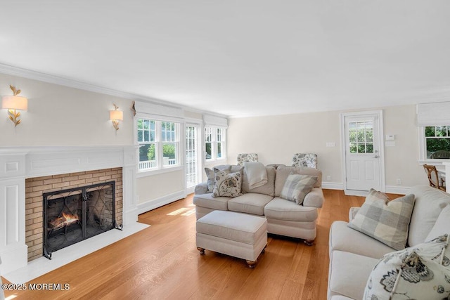 1905 3rd Ave, Spring Lake, NJ 07762 - living room with light wood-style floors, plenty of natural light, a fireplace, and ornamental molding