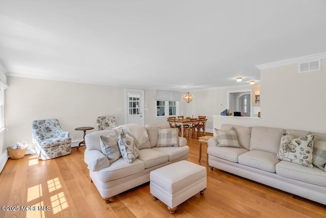 1905 3rd Ave, Spring Lake, NJ 07762 - living room featuring ornamental molding, light wood-type flooring, and a chandelier