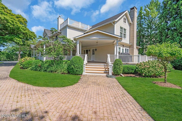 1905 3rd Ave, Spring Lake, NJ 07762 - view of front facade featuring a chimney, covered porch, and a front yard