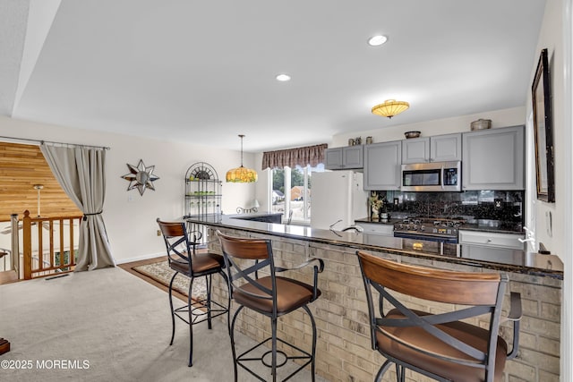 35 Tahoe Ln, Stafford, NJ 08050 - kitchen with appliances with stainless steel finishes, gray cabinetry, dark countertops, tasteful backsplash, and recessed lighting