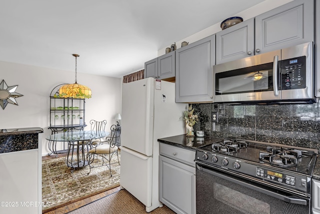 35 Tahoe Ln, Stafford, NJ 08050 - kitchen featuring stainless steel microwave, gas stove, freestanding refrigerator, backsplash, and pendant lighting