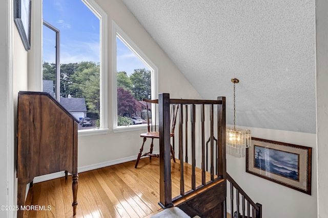 35 Tahoe Ln, Stafford, NJ 08050 - staircase with a textured ceiling, hardwood / wood-style floors, lofted ceiling, and a chandelier