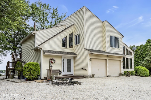 35 Tahoe Ln, Stafford, NJ 08050 - view of front of home with an attached garage, driveway, a shingled roof, and stairs