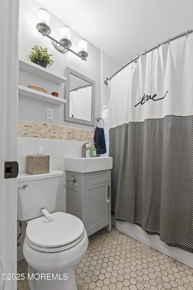 243 Donald Ave, Rahway, NJ 07065 - full bathroom featuring vanity, shower / tub combo with curtain, tile walls, and wainscoting