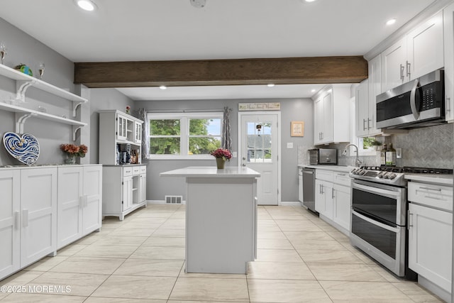 243 Donald Ave, Rahway, NJ 07065 - kitchen featuring appliances with stainless steel finishes, a kitchen island, backsplash, light countertops, and recessed lighting
