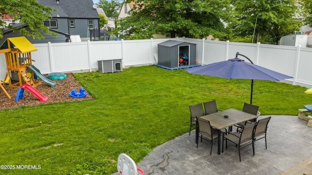 243 Donald Ave, Rahway, NJ 07065 - fenced backyard with a patio, a storage shed, a playground, and outdoor dining area