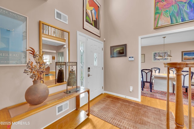 12 Diane Dr, Brick, NJ 08724 - foyer entrance featuring wood finished floors, a chandelier, and a high ceiling
