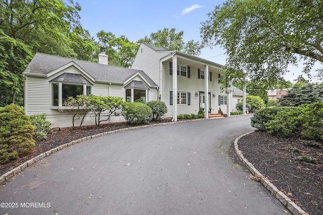6 Stoecker Rd, Holmdel, NJ 07733 - greek revival house featuring a chimney, driveway, and a shingled roof