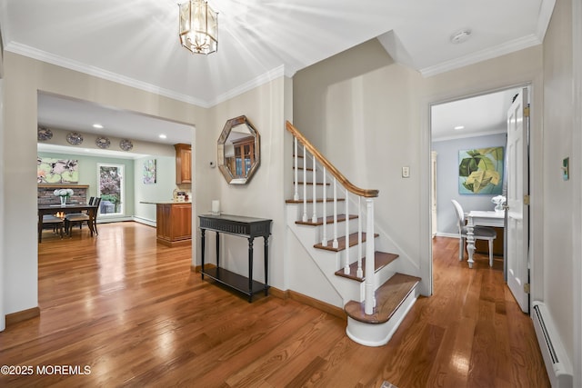6 Stoecker Rd, Holmdel, NJ 07733 - stairway with a baseboard radiator, wood finished floors, ornamental molding, and a chandelier