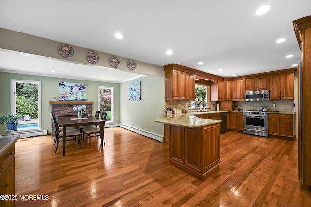 6 Stoecker Rd, Holmdel, NJ 07733 - kitchen with appliances with stainless steel finishes, a baseboard radiator, a peninsula, plenty of natural light, and recessed lighting