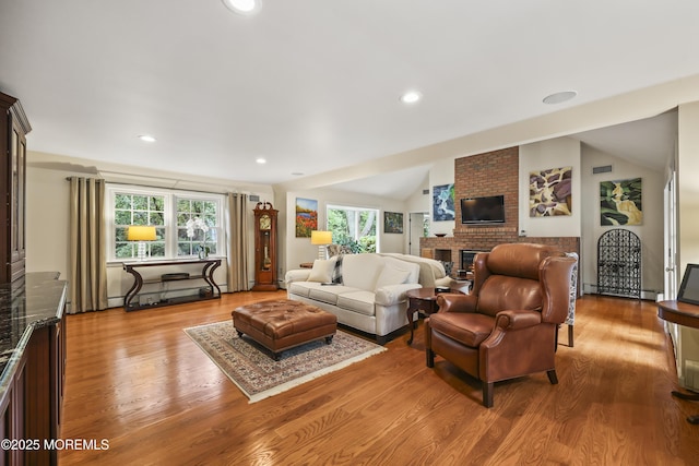 6 Stoecker Rd, Holmdel, NJ 07733 - living room with healthy amount of natural light, a fireplace, wood finished floors, recessed lighting, and lofted ceiling