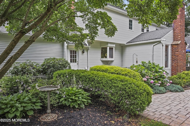 6 Stoecker Rd, Holmdel, NJ 07733 - view of front of home featuring a shingled roof and a chimney