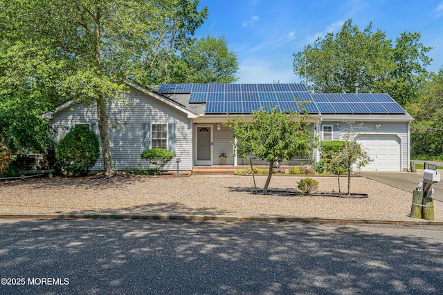 414 Riverview Rd, Forked River, NJ 08731 - ranch-style house featuring an attached garage, solar panels, and driveway