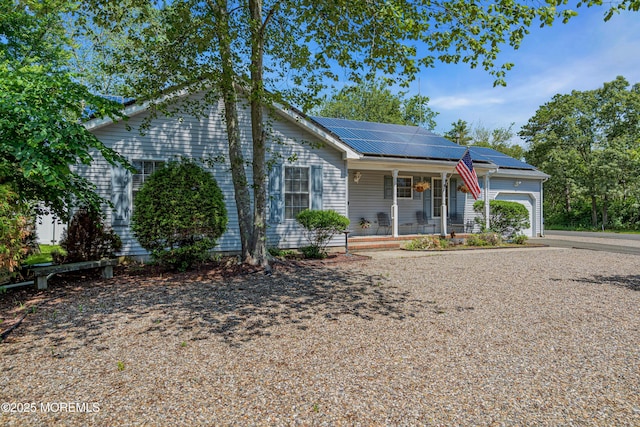 414 Riverview Rd, Forked River, NJ 08731 - ranch-style home with a porch, an attached garage, roof mounted solar panels, and driveway
