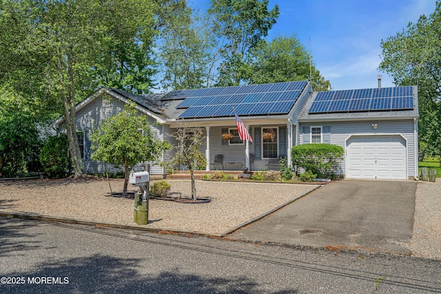 414 Riverview Rd, Forked River, NJ 08731 - ranch-style house with covered porch, a garage, asphalt driveway, and solar panels