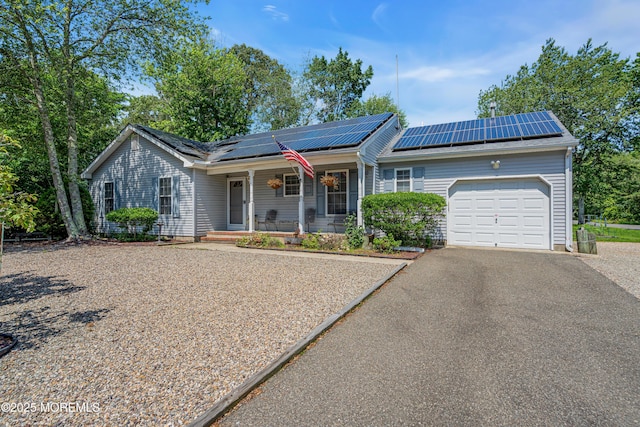 414 Riverview Rd, Forked River, NJ 08731 - single story home with a porch, a garage, driveway, and roof mounted solar panels