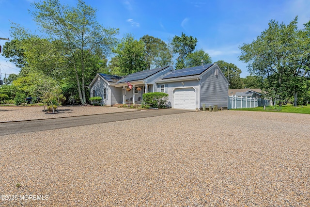414 Riverview Rd, Forked River, NJ 08731 - view of front of home featuring a garage, asphalt driveway, solar panels, and covered porch