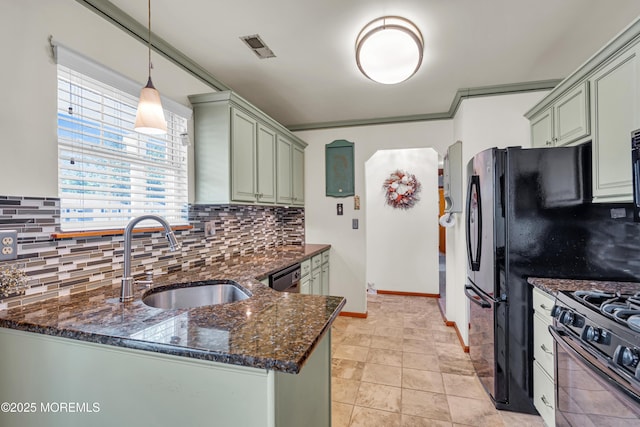 414 Riverview Rd, Forked River, NJ 08731 - kitchen with black gas range oven, decorative backsplash, dark stone counters, arched walkways, and pendant lighting