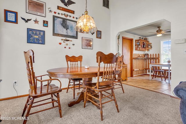 414 Riverview Rd, Forked River, NJ 08731 - dining space featuring ceiling fan, carpet, arched walkways, and a chandelier