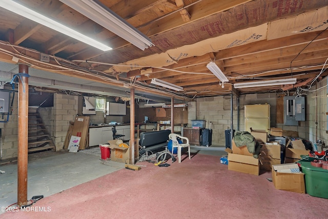 343 Clifton Ave, Bayville, NJ 08721 - basement featuring electric panel, stairs, freestanding refrigerator, and concrete block wall