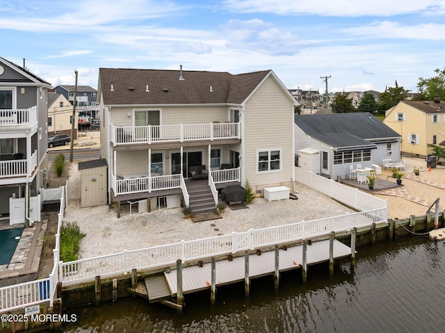 164 Morris Blvd, Beach Haven West, NJ 08050 - back of house with a fenced backyard, a deck with water view, and a residential view