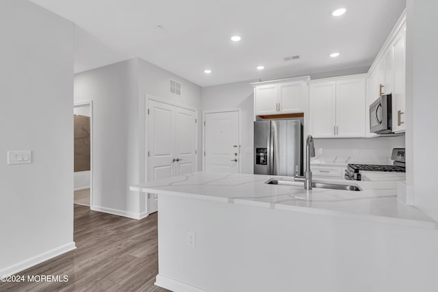 750 Lighthouse Dr Unit 1112, Barnegat, NJ 08005 - kitchen with stainless steel appliances, a peninsula, light stone countertops, wood finished floors, and white cabinets