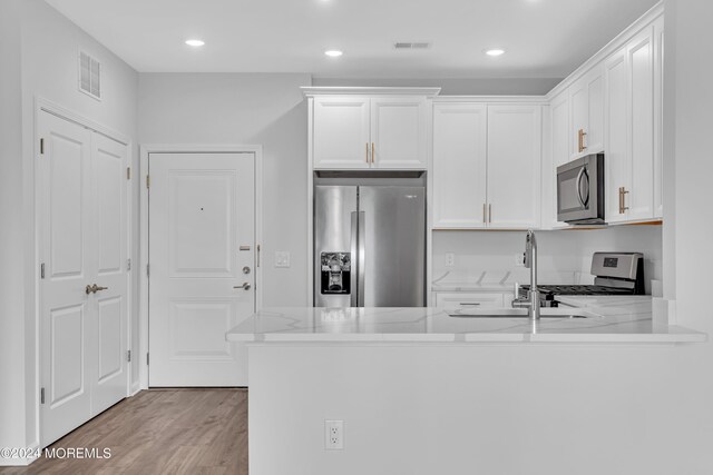 750 Lighthouse Dr Unit 1112, Barnegat, NJ 08005 - kitchen featuring stainless steel appliances, white cabinetry, a peninsula, light wood finished floors, and recessed lighting